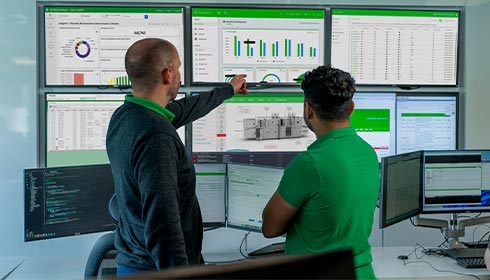A group of men looking at a computer screen