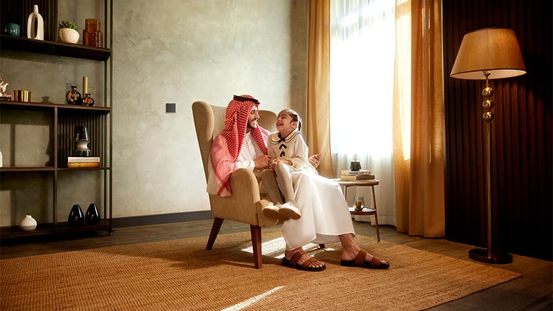 a man with his kid sitting on a chair