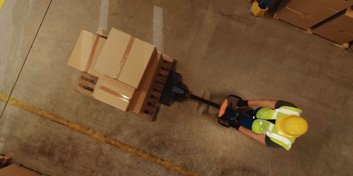man pull the heavy box in the factory