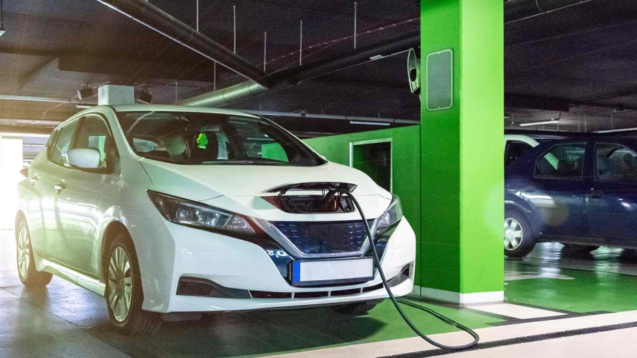White electric car charging at ev charging station