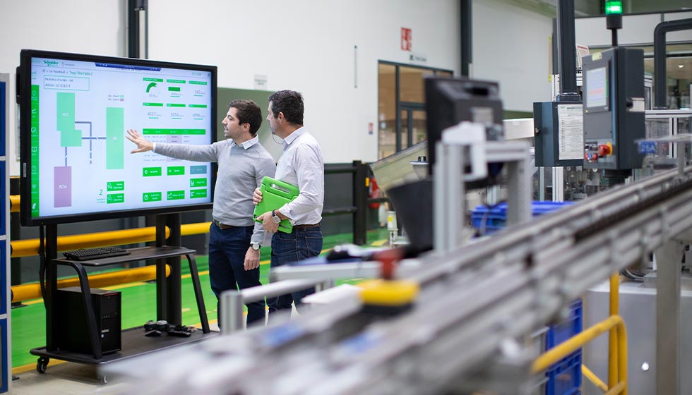 A group of men standing in a factory