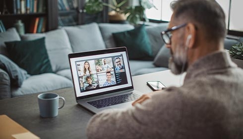 A person sitting at a table with a computer