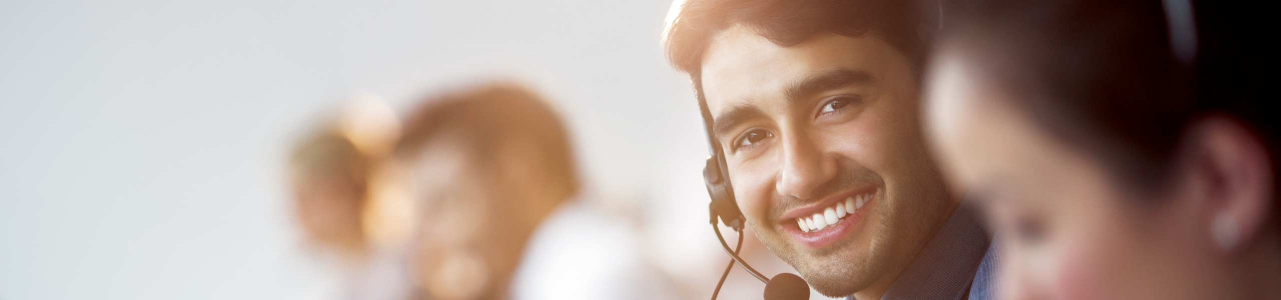 A member of a customer care team with a headset on