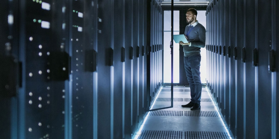 man with tablet in server room