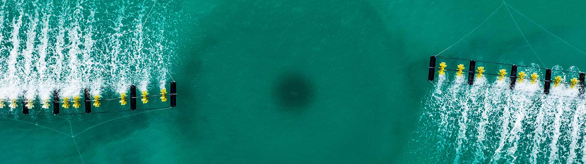 Aerial shot of drone looking down on a sprinkler in a water treatment tank