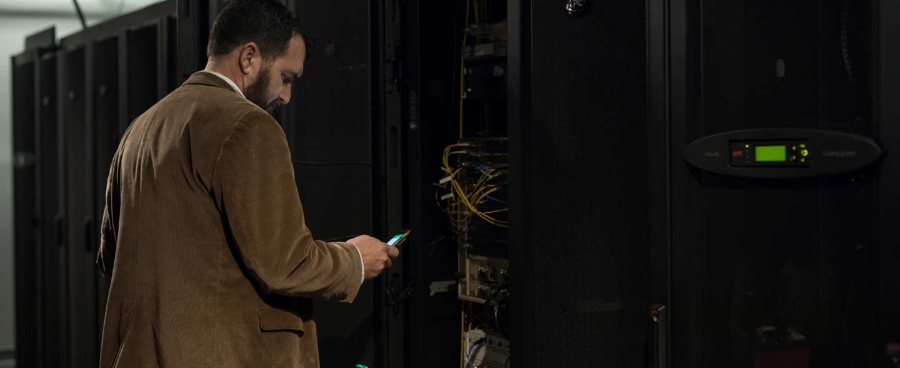 Man using smartphone in data centre at Retirement Systems of Alabama