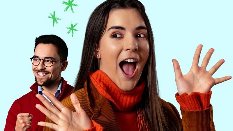A person with her mouth open and her hands up