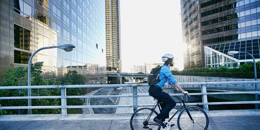 A person cycling in some corporate area