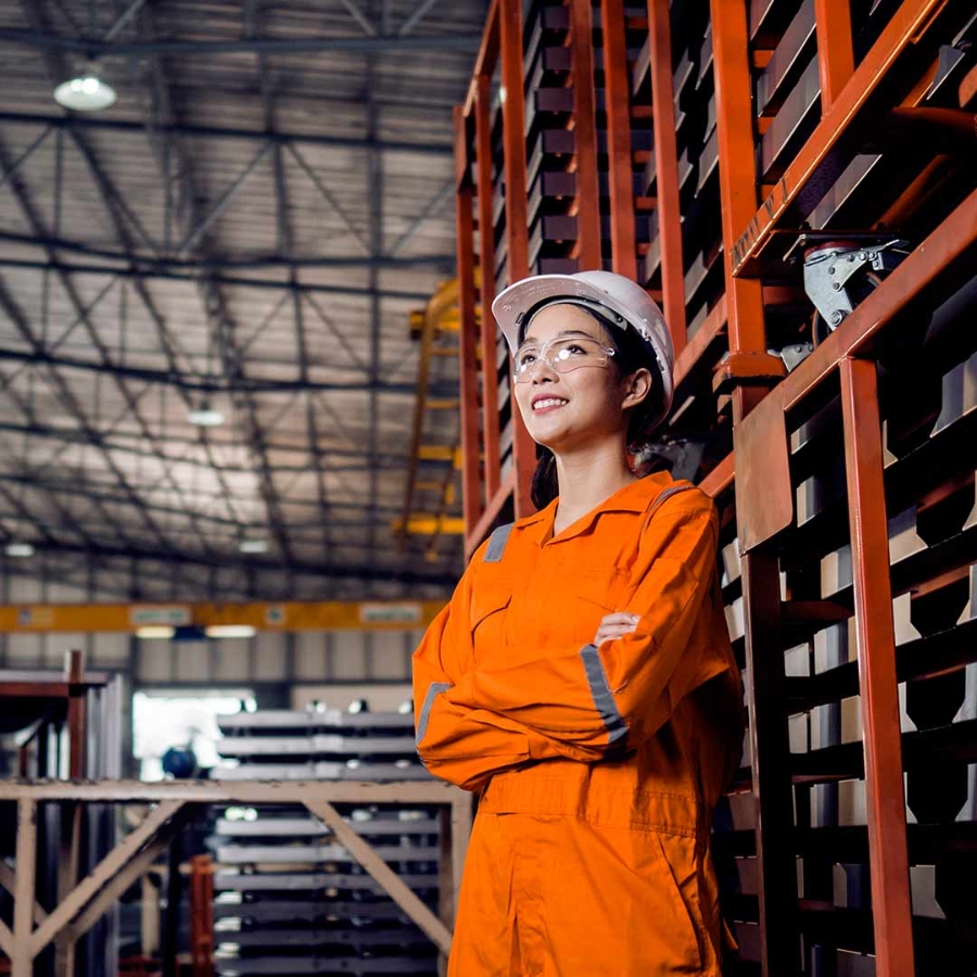A young woman in orange work clothes.