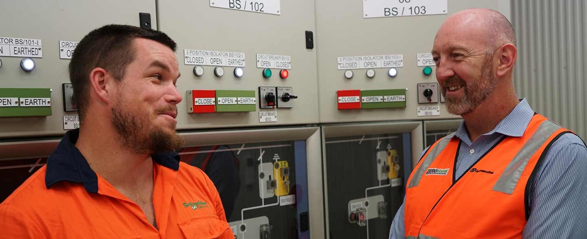 Two people wearing hi vis clothing at facility