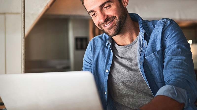 A person smiling at a computer