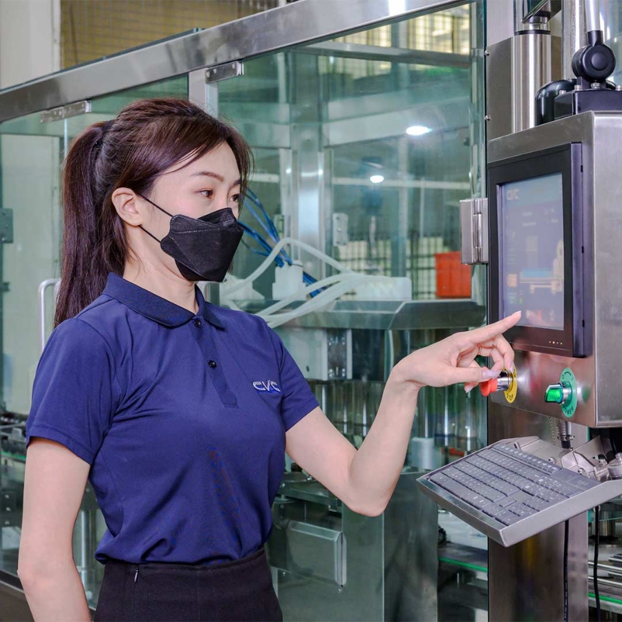A person wearing a mask and operating a machine