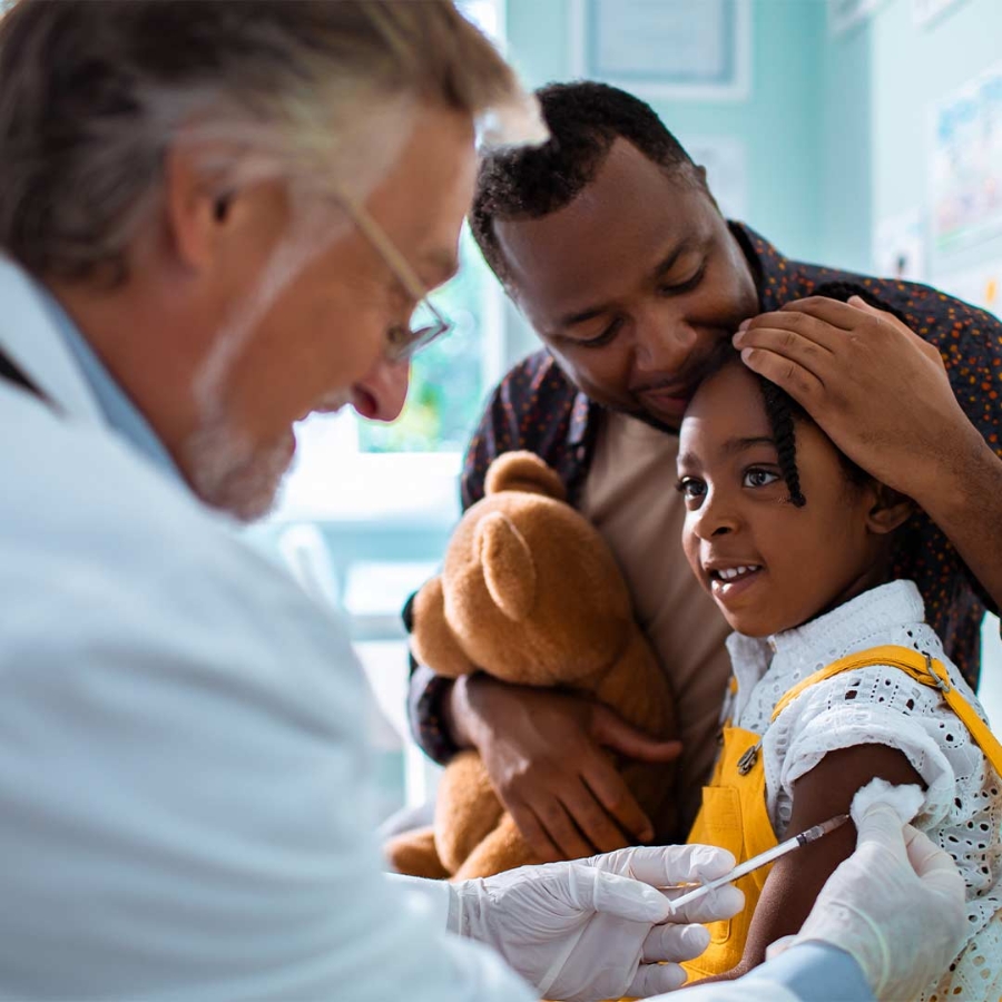 A doctor giving a shot to a child