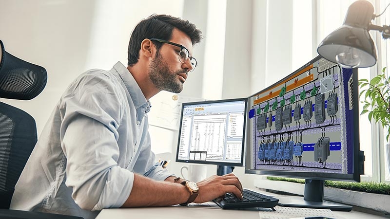 A person sitting at a desk using a computer