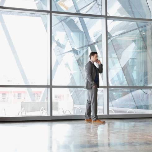 Businessman using mobile phone in office building