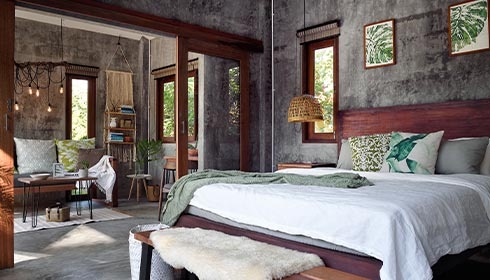 A bedroom with a bed and a bench