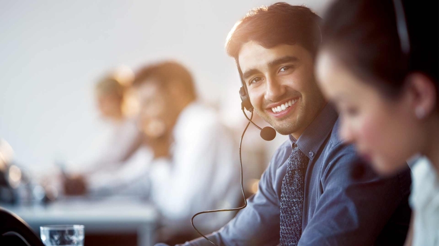 customer service executive smiling while talking on call in the call center