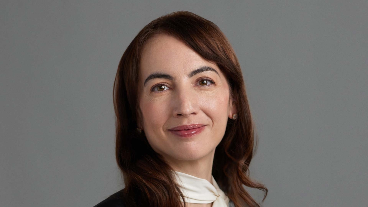 A person with brown hair and a white shirt