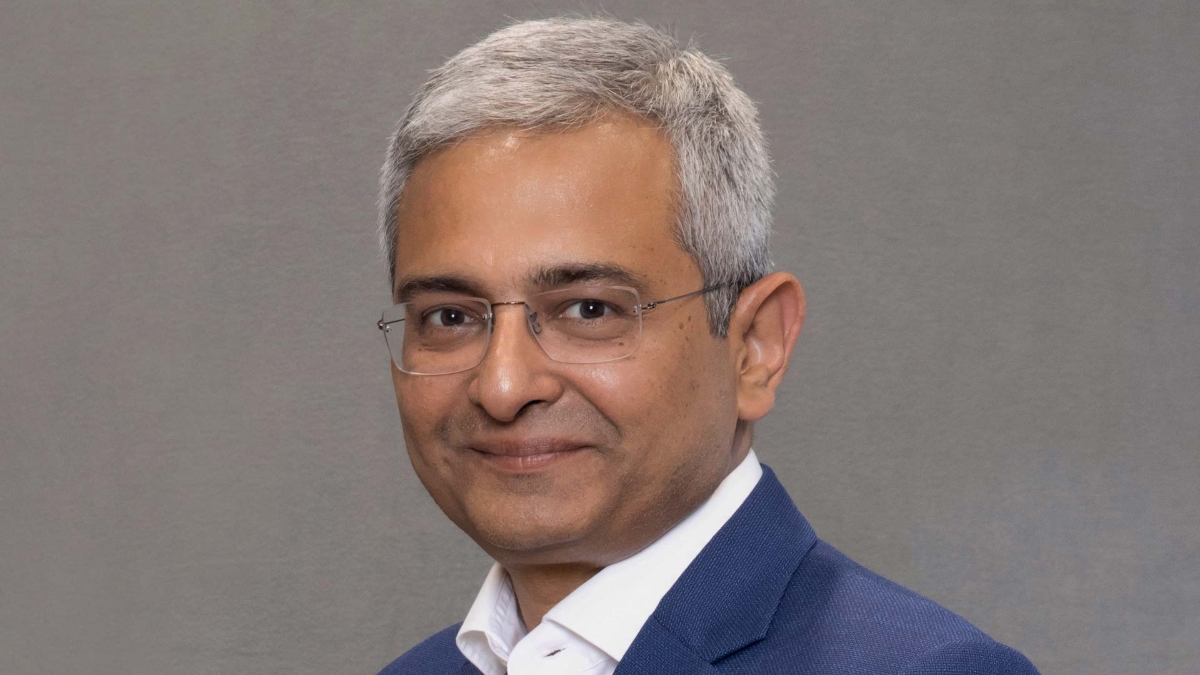 A person wearing glasses and a blue suit