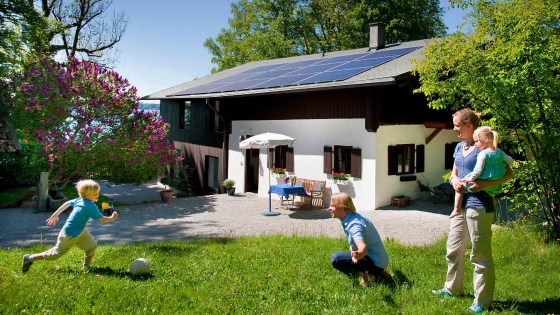 family playing outside their home in garden
