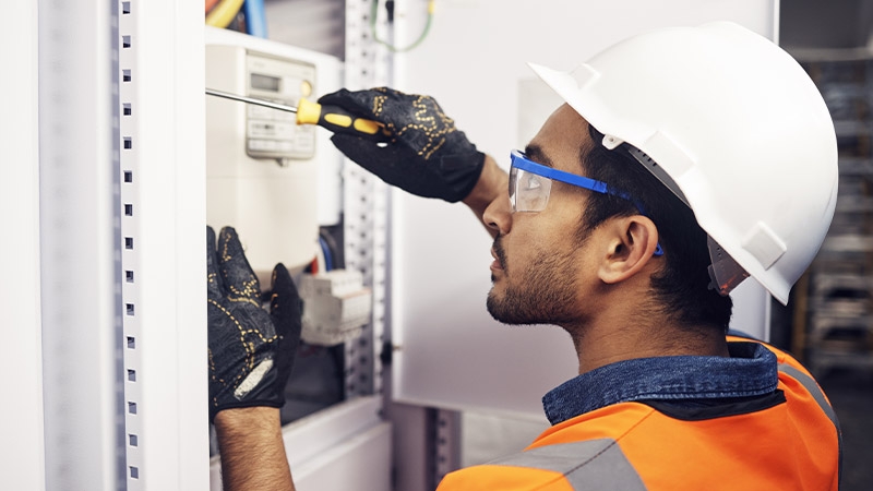 Male electrician, screw tool and power installation of industrial generator