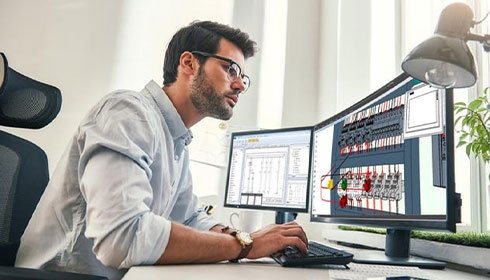 A person sitting at a desk using a computer