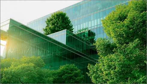 A glass building with trees in the background