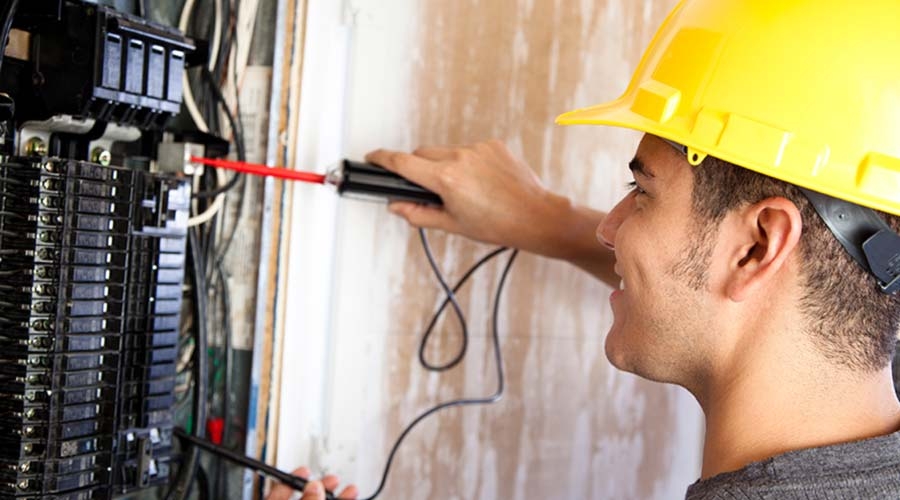 Electrician doing electrical work in breaker box