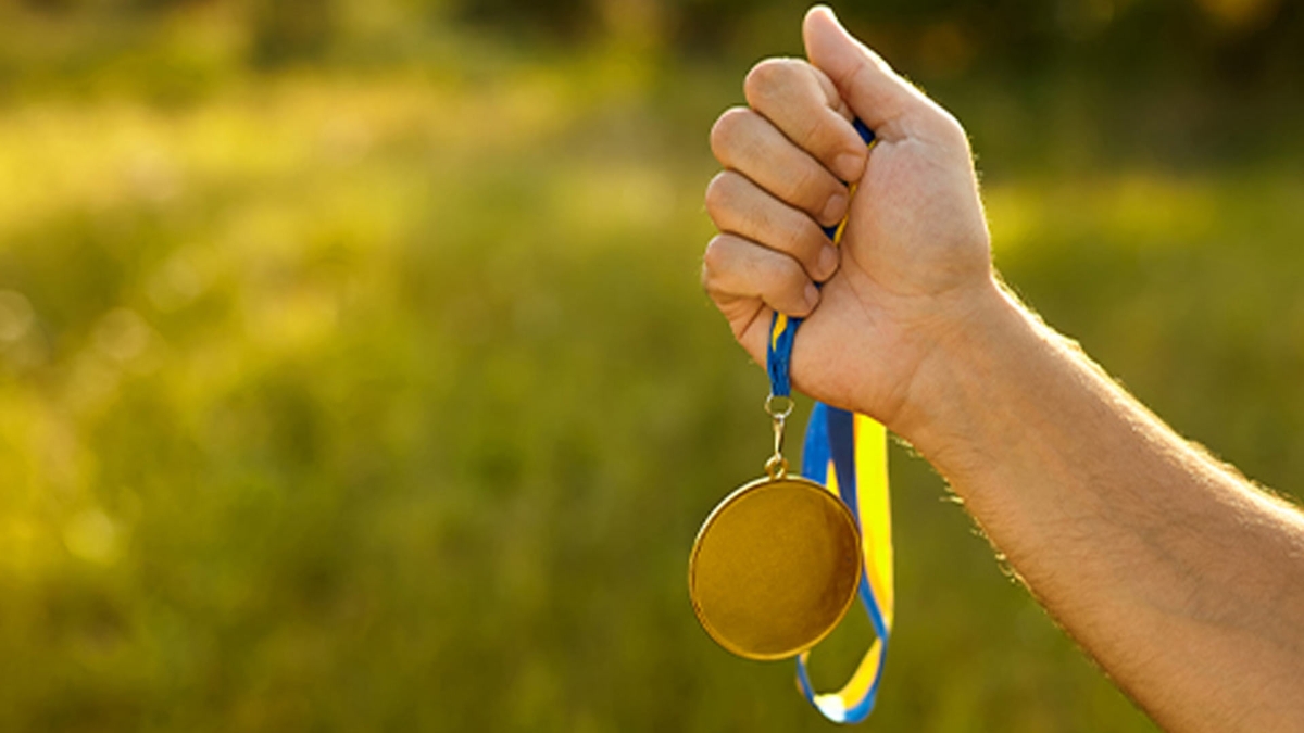 Sosteniendo una medalla de oro