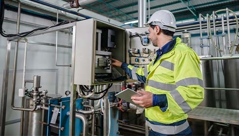 A person in a safety jacket and helmet