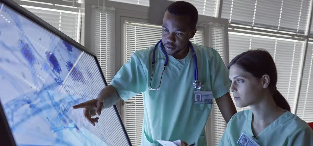 Nurses clipboard examining magnified microscope