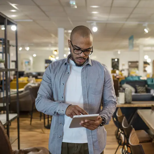 A close-up of a male sales assistant in a furniture store in Newcastle upon Tyne in the North East of England