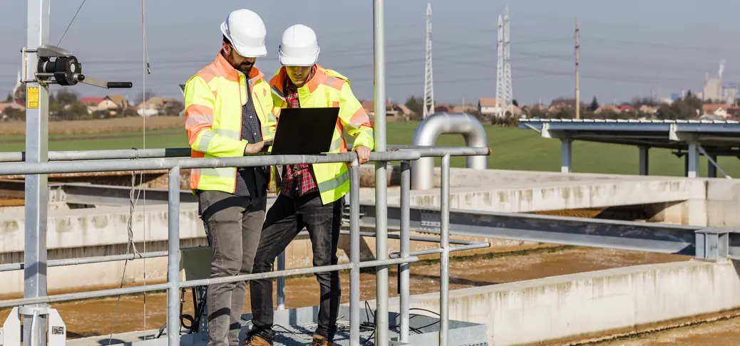 Business colleagues looking at laptop