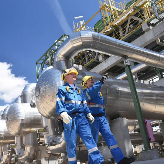 A group of men wearing hard hats and overalls