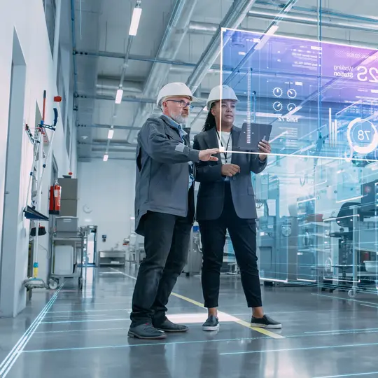 Two Industrial Engineers Use Tablet Computer