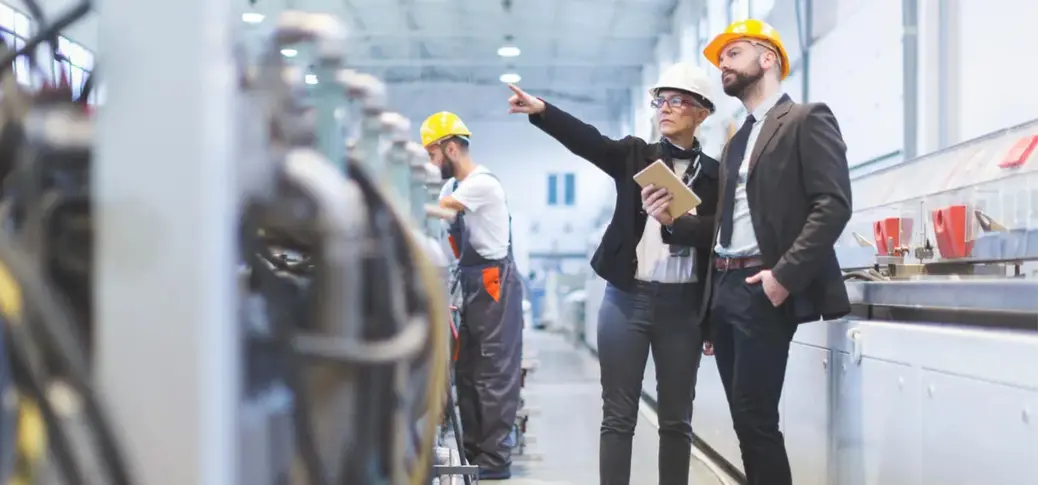 A person and person in hard hats