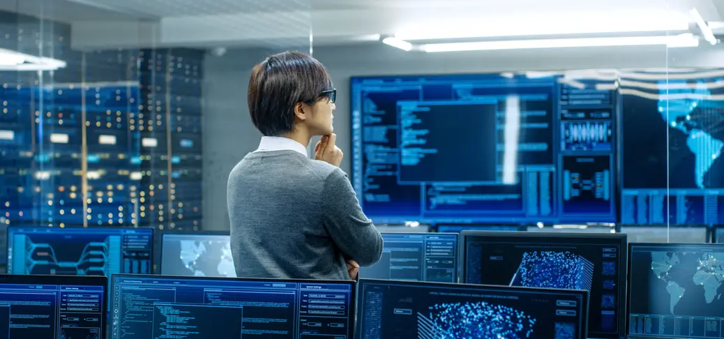 man standing at screens
