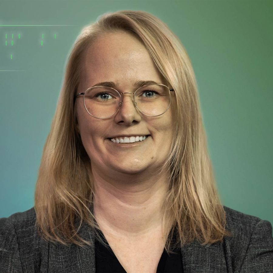 female person with glasses in front of a green background