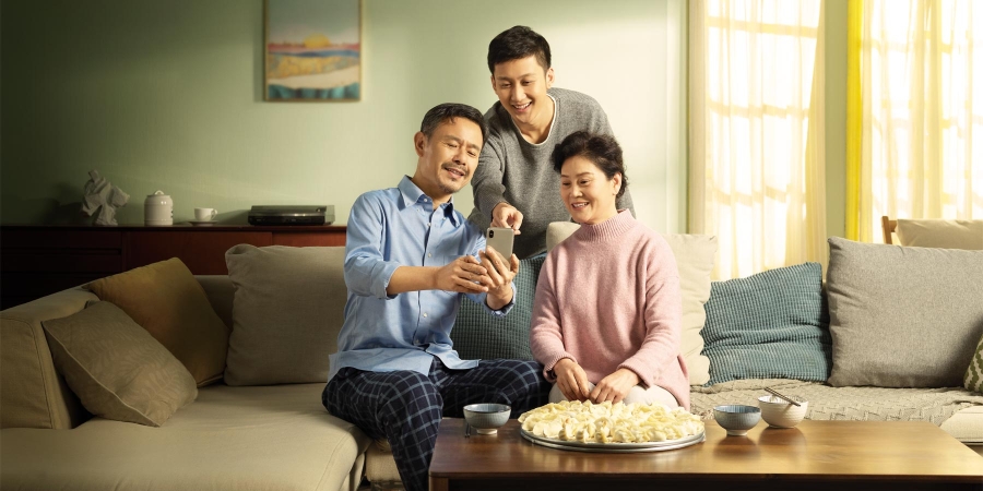 image of an Asian family sitting on sofa
