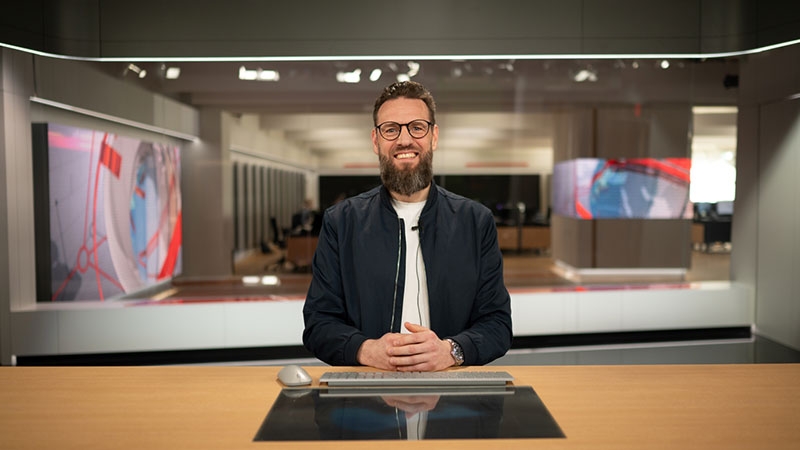 Man sitting at table in TV studio