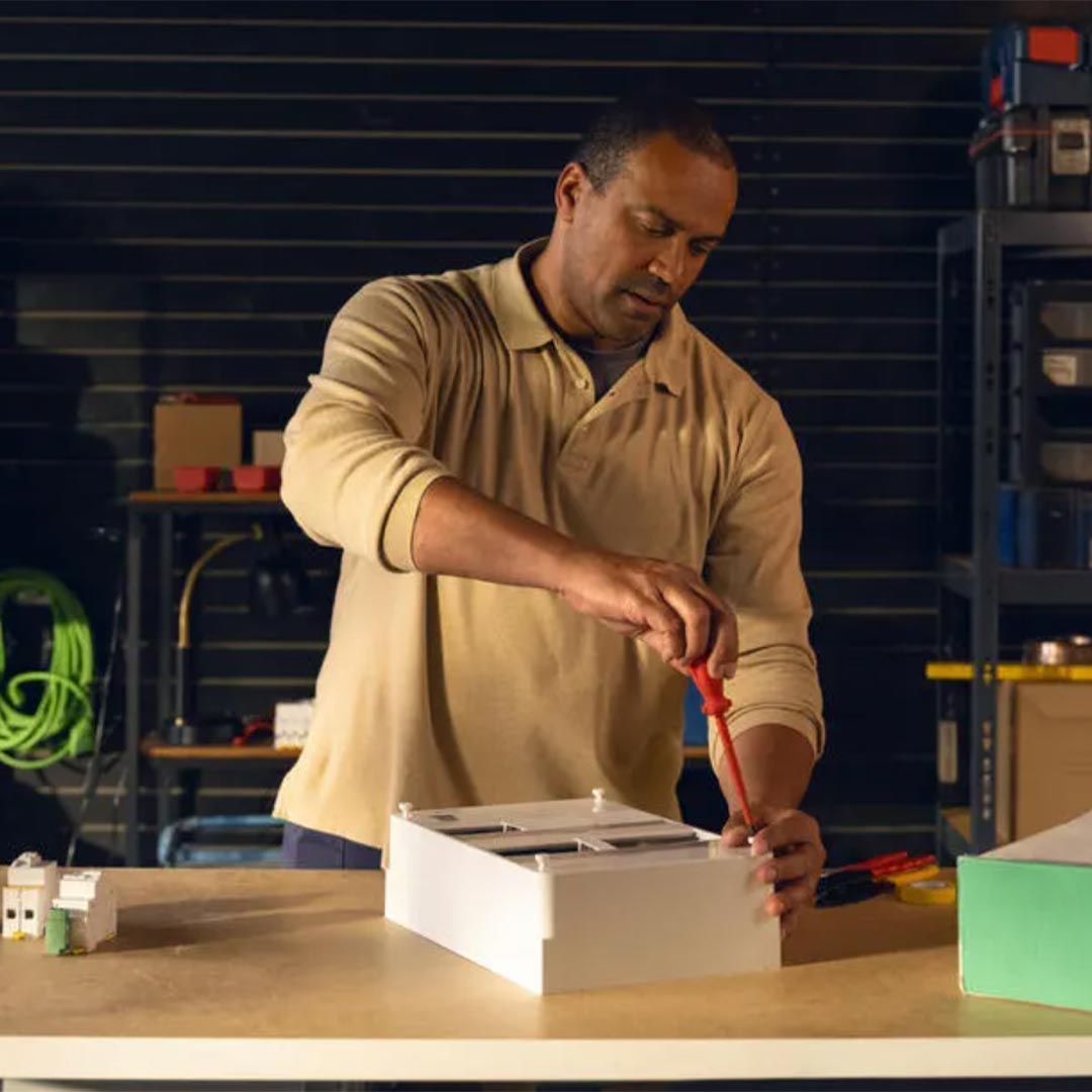 A person working on a white box