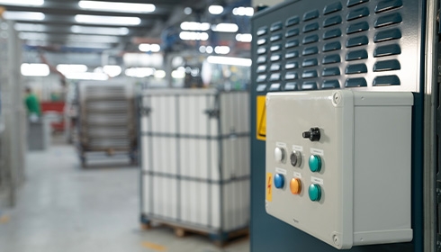 A control panel with buttons and a box in a factory