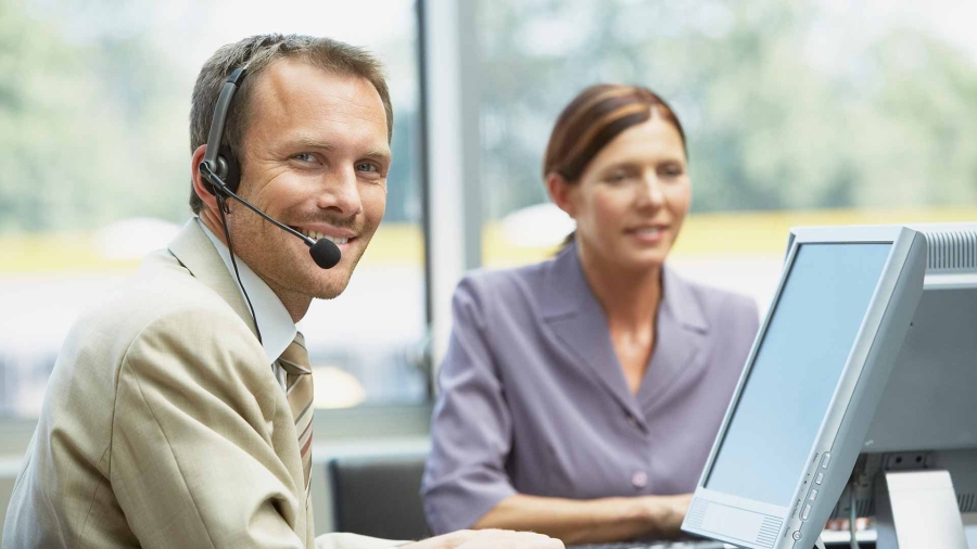 Customer care representative answering calls at office