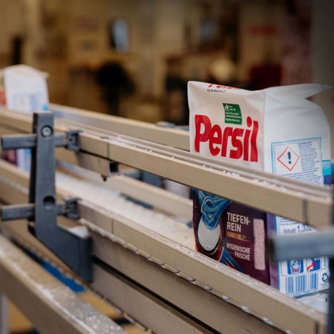 A bag of laundry detergent on a conveyor belt