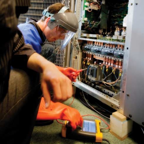 Technicians with face shields are working on servers, data center services.