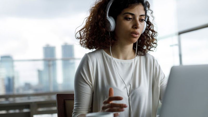 a young woman attending virtual meeting
