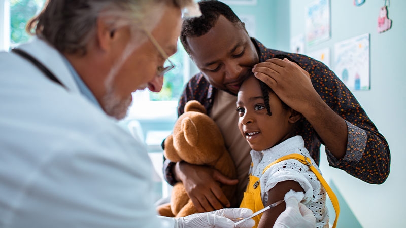 A doctor giving a shot to a child