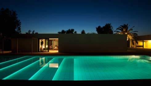 Pool outside modern house at twilight