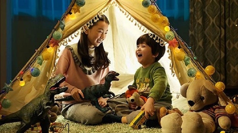 kids playing with toys on house tent 