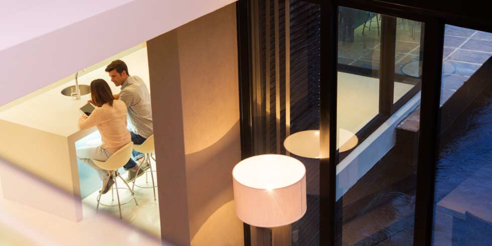Elevated view of couple using tablet pc in dining room